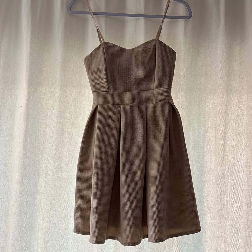 Cocktail dress, flowy mini skirt, padded top, adjustable strands.